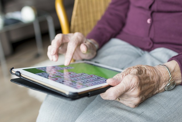 Resident playing solitaire on ipad